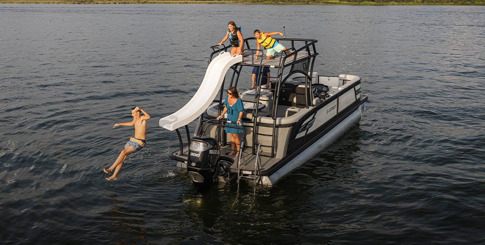 Professional pontoon boat on water, angled shot showing deck
